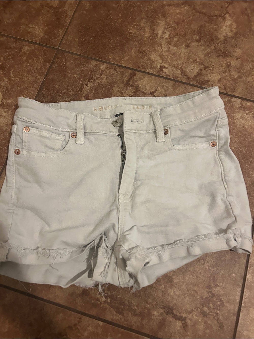 American Eagle tan Denim Jean Shorts with Frayed Hem and fold over at the bottom